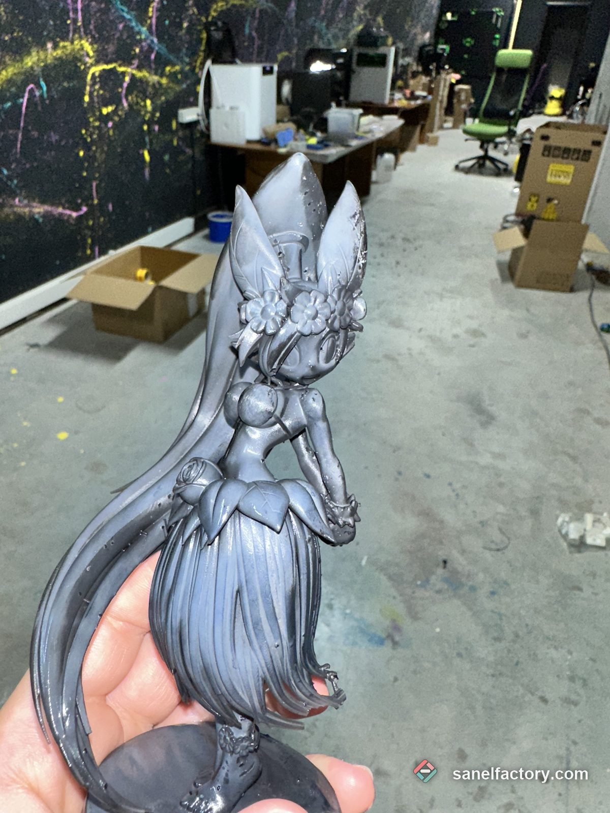 Figurină printată din rășină gri, ținută în mână în atelier